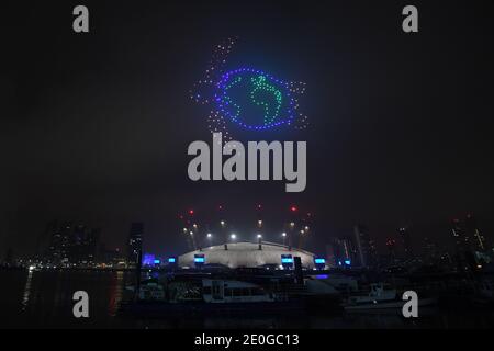 Fireworks and drones illuminate the night sky over London as they form a light display as London's normal New Year's Eve fireworks display was cancelled due to the coronavirus pandemic. Stock Photo