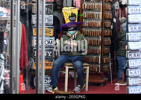 New York, USA. 31st Dec, 2020. A young boy wears a Planet Fitness New  Year's Eve hat as he sits in a shop along 8th Avenue as the ongoing  Coronavirus pandemic forces New York City to shut Times Square to people,  New York, NY, December 31, 2020