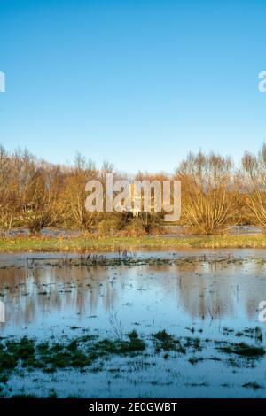Flooded fields along the river windrush around the cotswold village of Swinbrook on christmas eve 2020. Swinbrook, Cotswolds, Oxfordshire, England Stock Photo