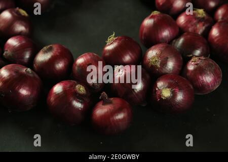 sweet red onions on background Stock Photo