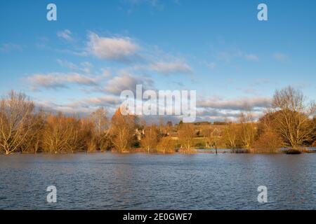 Flooded river windrush around the cotswold village of Swinbrook on christmas eve 2020. Swinbrook, Cotswolds, Oxfordshire, England Stock Photo