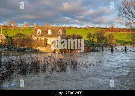 Flooded river windrush around the cotswold village of Swinbrook on christmas eve 2020. Swinbrook, Cotswolds, Oxfordshire, England Stock Photo