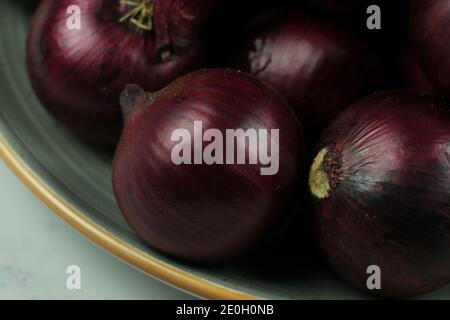 sweet red onions on background Stock Photo