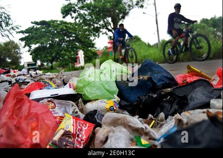 BEKASI, INDONESIA - 1 JANUARY 2021: Piles of garbage on the side of a highway in the Tambun area, Bekasi, West Java, Indonesia, January 1, 2021. The v Stock Photo