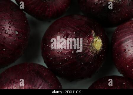 sweet red onions on background Stock Photo