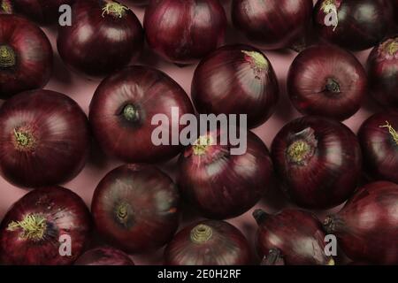 sweet red onions on background Stock Photo