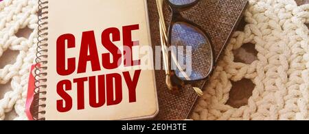 Case study memo written on a notebook with pen, glasses on crochet cloth. Successful business cases educational concept Stock Photo