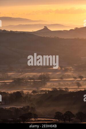 Lamberts Castle, Dorset, UK. 1st Jan, 2020. UK Weather: Beautiful New Years Day sunrise over the frost layered rural landscape of Marshwood Vale with the iconic landmark of Colmers Hill seen in the distance. Credit: Celia McMahon/Alamy Live News Stock Photo