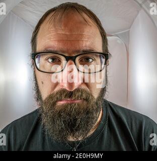 A bearded sad looking man in a depressive mood Stock Photo