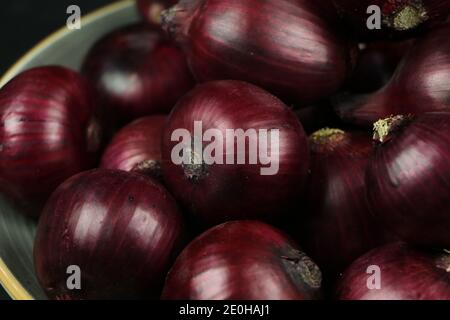 sweet red onions on background Stock Photo