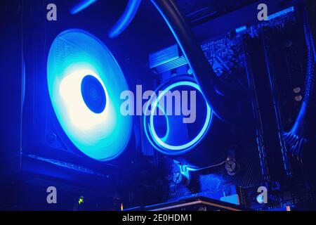 Open computer system unit with blue neon light water cooling Stock Photo