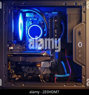 Computer components inside the system unit with blue light liquid cooling Stock Photo