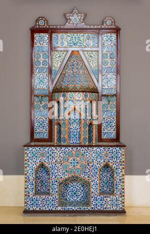 Old Ottoman era style castle shaped fireplace, decorated with floral patterns ceramic tiles from Turkish Iznik town Stock Photo