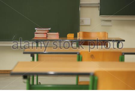 Empty desks in a classroom in Germany as students are forced to remain at home and do distance learning due to Corona virus. Stock Photo