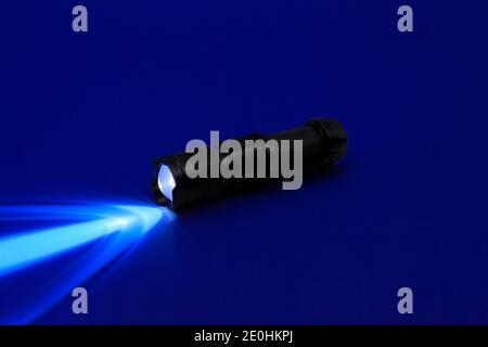 Mini UV LED Flashlight. Ray of ultraviolet light UV-365 nm. Stock Photo