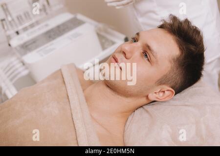 Close up of an attractive young man relaxing at beauty salon before skincare treatment Stock Photo