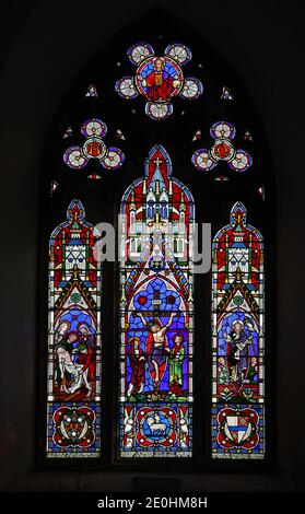 A stained glass window by Clayton & Bell depicting The Crucifixion, Deposition and Resurrection of Jesus, St Margaret's Church, Witton, Norfolk. Stock Photo