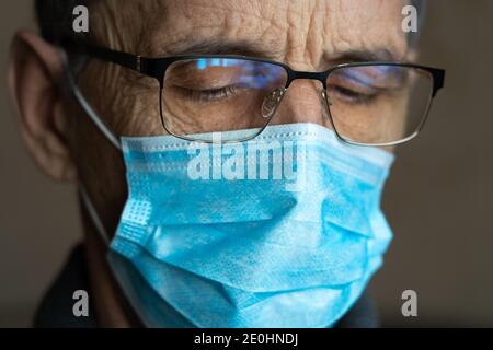 Portrait of an elderly man in glasses and a medical mask Stock Photo