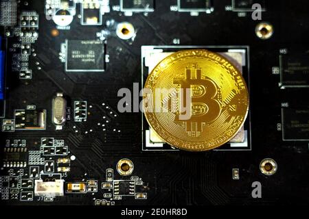 Bitcoin Coin is Included Instead of Microprocessor. The Electronic Board. Cryptocurrency Mining Concept. Printed Circuit Board With a Processor and a Stock Photo