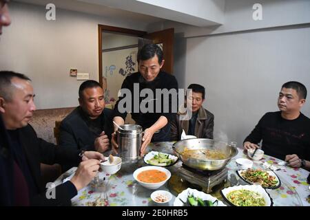 (210101) -- CHANGSHA, Jan. 1, 2021 (Xinhua) -- Shi Zhongfang (C) serves the customers at his restaurant in Yuanjiang City, central China's Hunan Province, Dec. 21, 2020. Shi Zhongfang, a former fisherman in Lianhua'ao Island which is located in the middle of Dongting Lake, now runs a restaurant featuring the traditional fish cuisine of fishermen in Yuanjiang City. He was the seventh generation fisherman in his family and started fishing at the age of 14. His life has changed in the wake of a fishing ban. According to the central government's plan, a complete 10-year fishing ban is impose Stock Photo