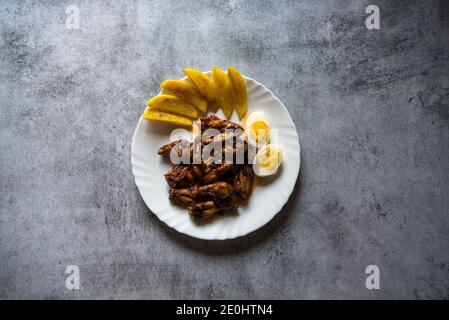 Slice of boiled egg along with honey glazed chicken wings Stock Photo