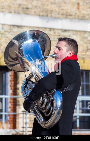 Brass band member playing euphonium tuba musical instrument at Victorian Festival of Christmas at Portsmouth, Hants England UK in December Stock Photo