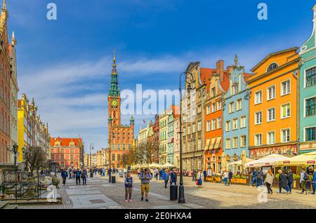 Gdansk, Poland, April 15, 2018: cityscape with people tourists walking down Dluga Long Market pedestrian street Dlugi targ square, City Hall and typical colorful houses in old town historical centre Stock Photo