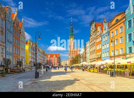 Gdansk, Poland, April 15, 2018: cityscape with people tourists walking down Dluga Long Market pedestrian street Dlugi targ square, City Hall and typical colorful houses in old town historical centre Stock Photo