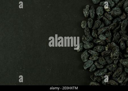Dried raisins on black background Stock Photo