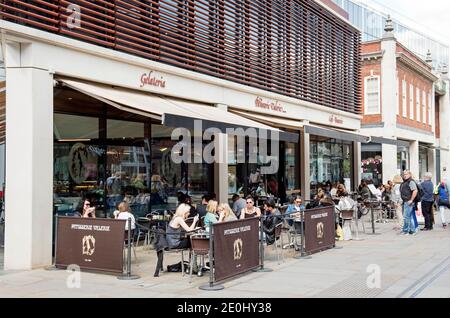 People sitting and eating outside Patisserie Valerie on a summers day Brushfield Street Spitalfields Market London Borough of Tower Hamlets. Summer. Stock Photo