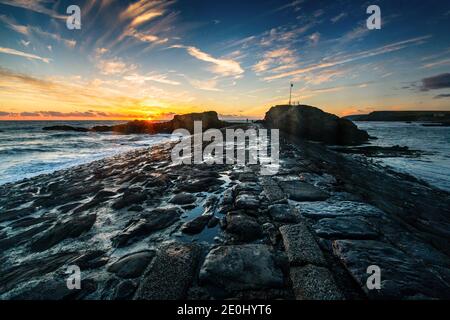 Sunset over the breakwater at Bude in North Cornwall, England, Uk Stock Photo