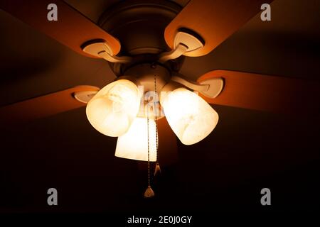 Overhead fan with three bright lights turned on Stock Photo