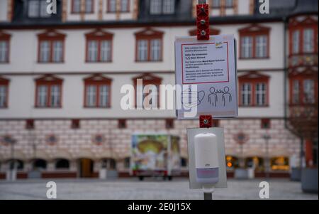 Coburg, Germany. 01st Jan, 2021. A disinfectant dispenser has been set up on Coburg's market square. The city of Coburg has tightened its Corona regulations due to further increasing infection figures. From this Thursday (31.12.2020) onwards, only two specifically named households with a maximum of five adults may visit each other. Credit: Nicolas Armer/dpa/Alamy Live News Stock Photo