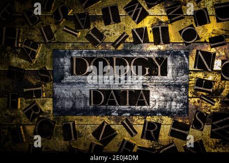 Dodgy Data text surrounded by letters on grunge textured copper and gold background Stock Photo