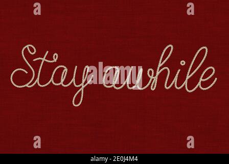 cursive font stay while text in rope effect on a textured red background Stock Photo