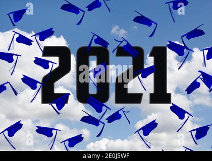 airborne blue graduation caps with 2021 text in blue sky with clouds Stock Photo