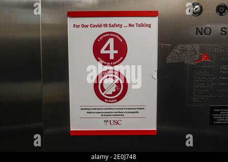 Signage in an elevator near the Galen Center warns of no talking due to the novel coronavirus outbreak before an NCAA basketball game between the Sout Stock Photo