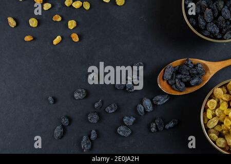 Dried raisins on black background Stock Photo