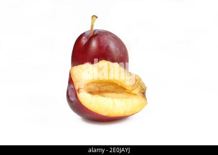 One whole and a half plum. Fresh fruit closeup Stock Photo