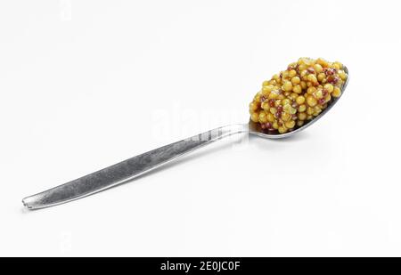 Whole grain french mustard in metallic spoon isolated on white background Stock Photo