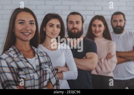 Group of young creative businesspeople smiling to the camera. Diverse team of successful entrepreneurs posing proudly together. People, diversity, uni Stock Photo