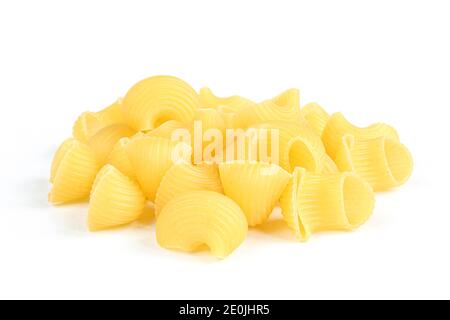 Portion of uncooked pasta snails isolated on white background.  Dry Italian rigate dish Stock Photo