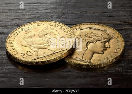 French 20 Francs gold coins on rustic wooden background Stock Photo