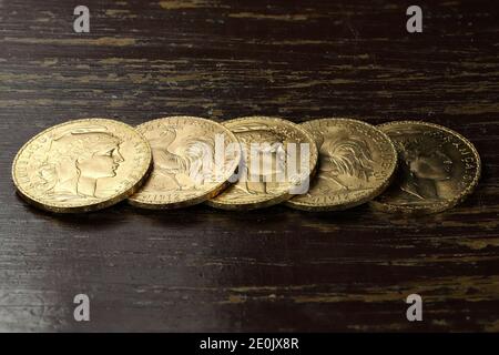French 20 Francs gold coins on rustic wooden background Stock Photo