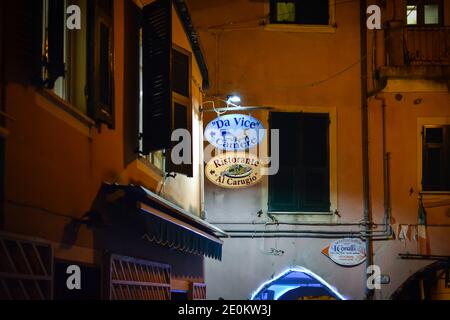 Night view of the Al Carugio Restaurant and Da Vice Inn sign in the village of Monterosso al Mare, Italy, part of the Cinque Terre. Stock Photo