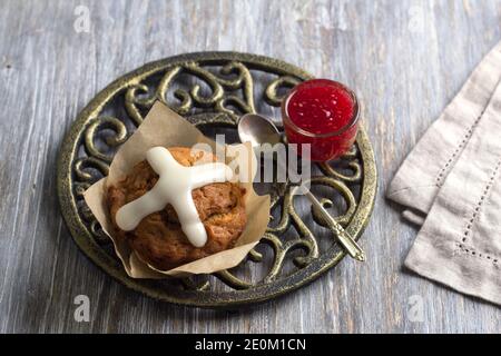 Easter cross muffins with raisins, cranberries and raspberry jam on a wooden table, top view Stock Photo