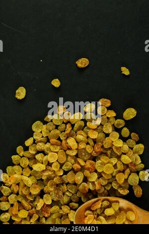 Dried raisins on black background Stock Photo