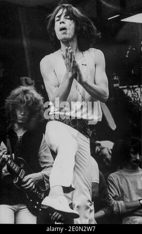 Mick Jagger performing at the Rolling Stones free concert in Hyde Park, London, July 5, 1969. Guitarist in background left is Mick Taylor. This was his first outing with the Stones after the recent death of Brian Jones. Stock Photo