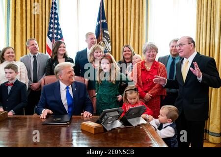 Washington, United States Of America. 07th Dec, 2020. President Donald J. Trump is joined by Olympic wrestling champion Dan Gable and his family during the Presidential Medal of Freedom Ceremony for Gable Monday, Dec. 7, 2020, in the Oval Office of the White House. People: President Donald Trump, Dan Gable Credit: Storms Media Group/Alamy Live News Stock Photo