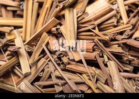 Organic dried lemongrass, latin name cymbopogon citratus heap extreme close-up view on white background Stock Photo